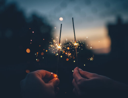 couple celebrating new years goals with sparklers