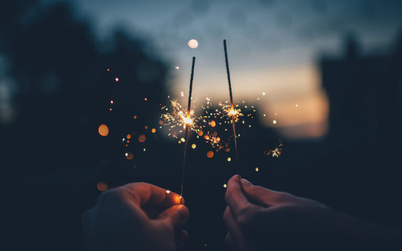 couple celebrating new years goals with sparklers